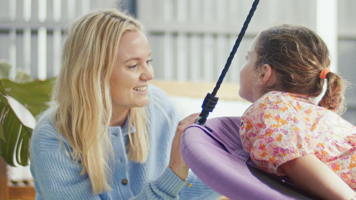 Hayley with a young client on the sensory swing